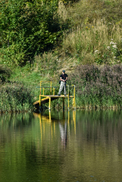 Ο άνθρωπος πιάνει ψάρια στη λίμνη - Φωτογραφία, εικόνα