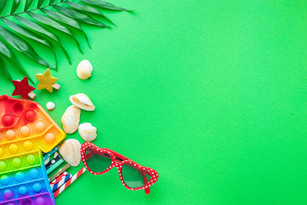 summer mood background tropical leaf, sunglasses, seashell, cocktail tubes travel accessories vacation summer relax mood top view - Photo, Image