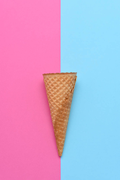 An Ice Cream Cone on a blue and pink background. Flat lay minimalist styling.  - Zdjęcie, obraz