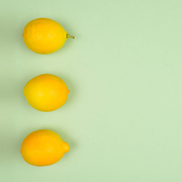 Top view flat lay fresh picked lemons on a pastel green background.  - Foto, Imagem