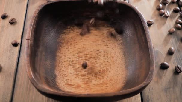 Roasted coffee beans slowly falling into a plate - Footage, Video