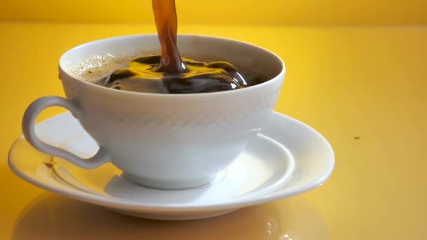 A piece of sugar slowly falls into a cup of coffee with splashes. - Footage, Video