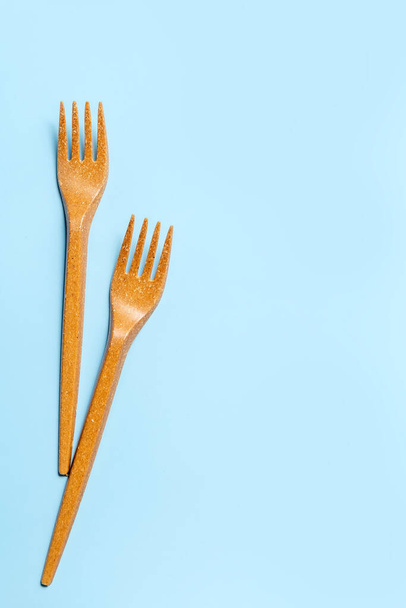 Disposable plastic forks on a blue background. Disposable tableware. Concept. Place for your text. - Photo, Image
