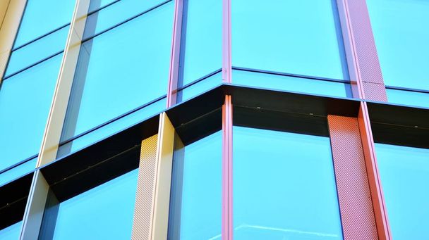 Fachada de cristal de los edificios con cielo azul. Edificio moderno en el centro de negocios. Antecedentes de edificios modernos de vidrio.  - Foto, Imagen