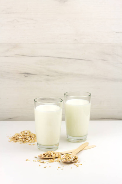 Oat milk in glasses and ingredients with copy space - Zdjęcie, obraz