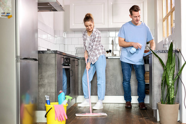 Two Janitors Cleaning Kitchen And Mopping Floor At Home - Foto, imagen