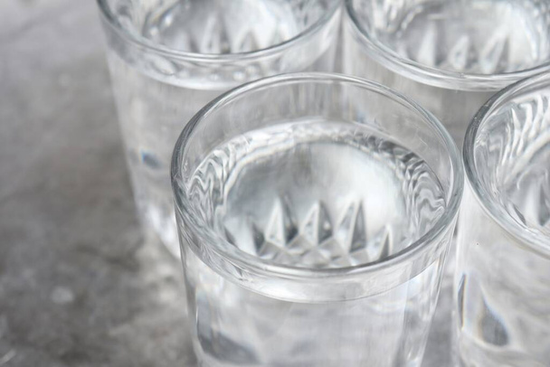 Close up of water drink on glass on gray background - Фото, зображення