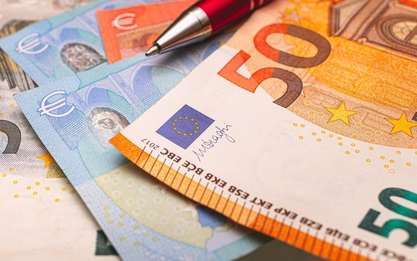 Money, Euros. European Union currency. Euro banknote and pen in an office environment. Close up photo. - Zdjęcie, obraz