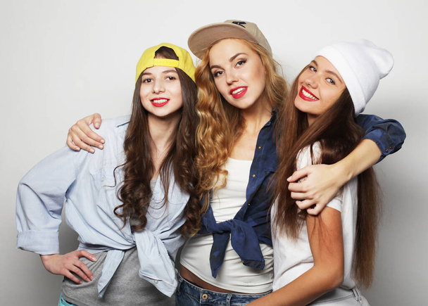 Three young girl friends standing together and having fun. - Foto, Imagen