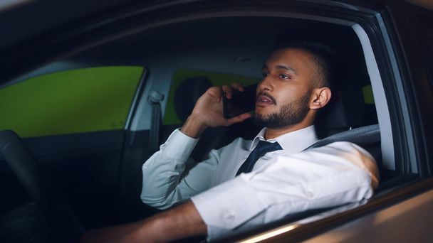 Indian Businessman Sitting In The Car Driving And Talking On Phone - Parking Lot - Photo, Image