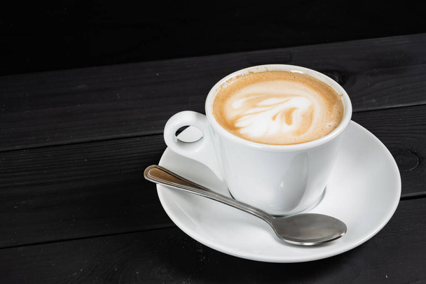 cup of cappuccino on the black background - Foto, imagen