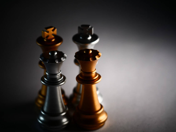 A closeup shot of gold and silver chess pieces - Foto, immagini