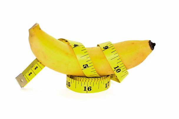 Banana and Yellow tape measure for The symbol of the penis size - Foto, Imagen