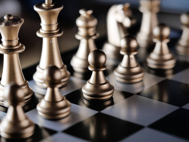 A closeup shot of metallic golden chess pieces - Photo, image