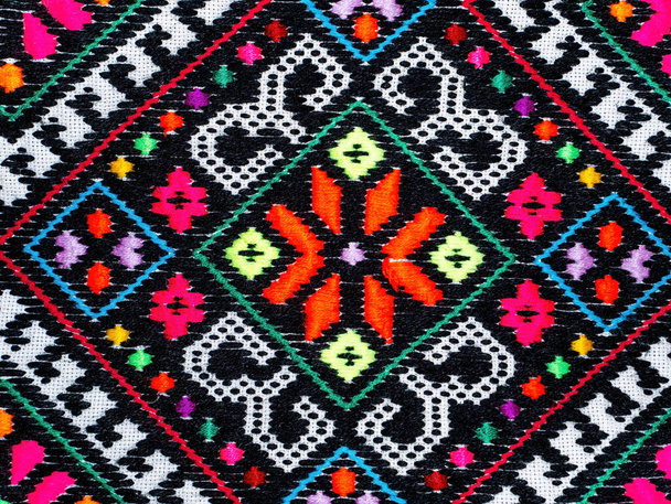 Part of the pattern of Ukrainian colored embroidery. Ukrainian culture. Traditional retro handicrafts. National tradition. Background image. Bright colors. Retro style. History of the country. - Photo, Image