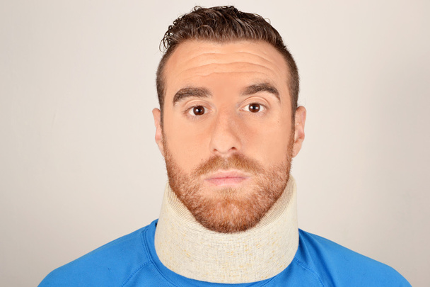 Portrait of a young man suffering from neck pain - Photo, Image