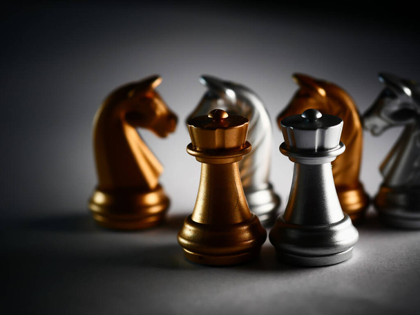 A closeup shot of metallic gold and silver chess pieces - Zdjęcie, obraz