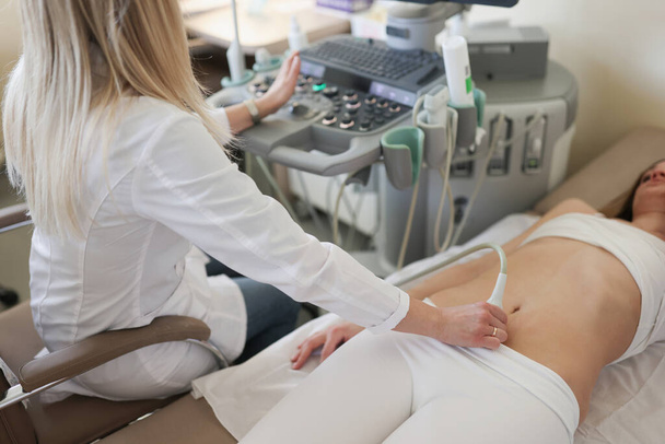 Sonographer hand examining woman with ultrasound scanner - Photo, Image