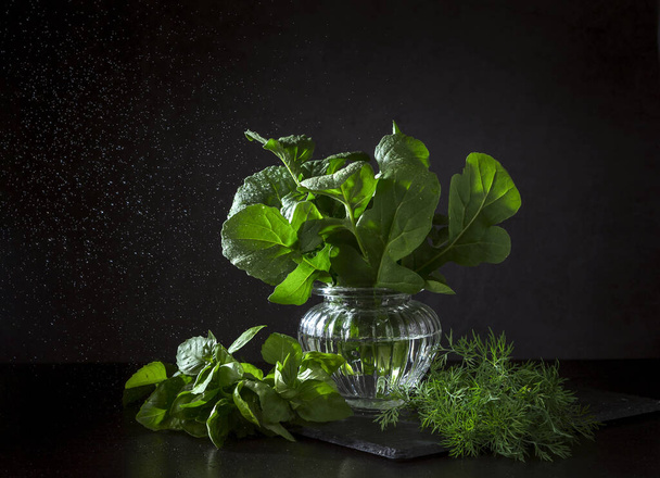 Arugula, basil and dill leaves on a dark background. - Photo, Image