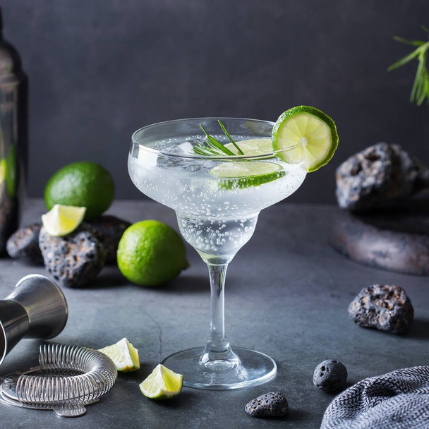 Hard seltzer cocktail with lime, rosemary and bartenders accessories - Photo, Image