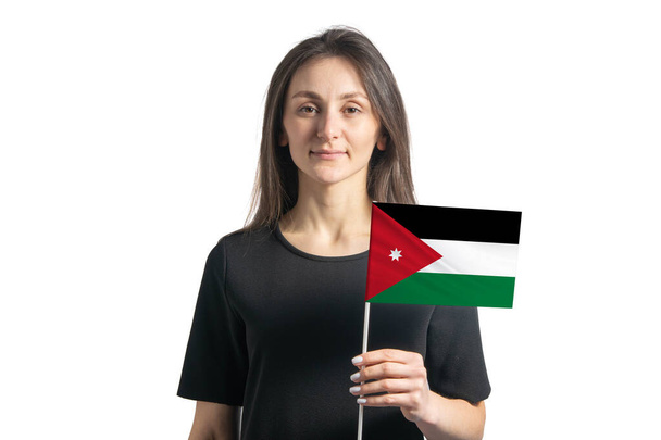 Счастливая молодая белая девушка держит флаг Иордании изолированы на белом фоне. - Фото, изображение