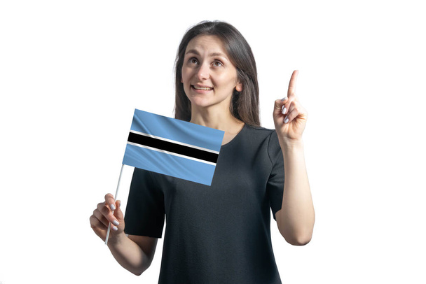 Happy young white woman holding flag of Botswana and points thumbs up isolated on a white background. - Photo, Image