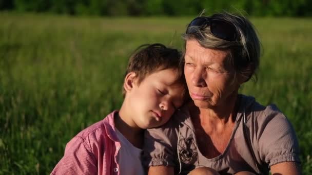 little caucasian boy sleep on grandmothers shoulder. Grandson. - Footage, Video