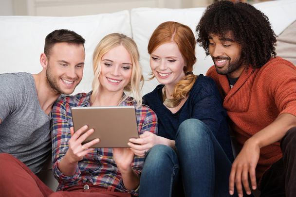 Group of happy young friends using a tablet - 写真・画像
