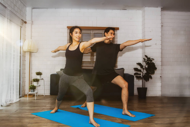 Asian couples doing home exercises for good health and warm family relationships show each other love and happiness at home. - Фото, изображение