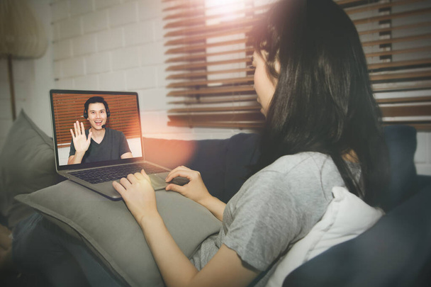Concept of a new normal life : Video call between couples chatting through tablet PC cameras in the house, greeting of man and lover towards women lovers in long distance relationship together. - Photo, image