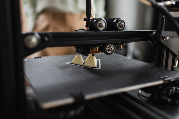 close up view of 3D printer creating plastic figure in modern office - Fotoğraf, Görsel