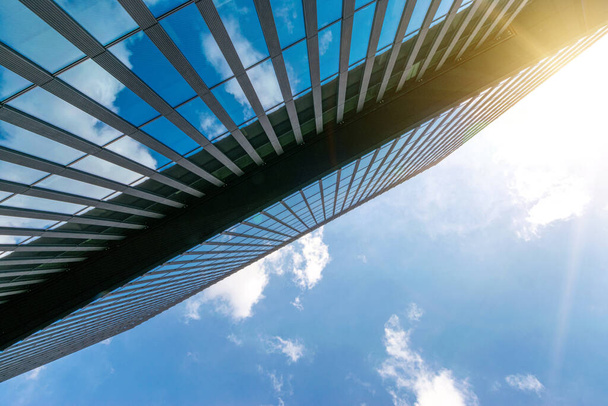 Γυαλί κτιρίων της πόλης. Σύγχρονο κτίριο επιχειρήσεων γραφείων με γυαλί, πρόσοψη χάλυβα εξωτερικό. Χρηματοδότηση εταιρική αρχιτεκτονική πόλη στην αφηρημένη μπλε του ουρανού με τη φύση σύννεφο στην ηλιόλουστη μέρα - Φωτογραφία, εικόνα