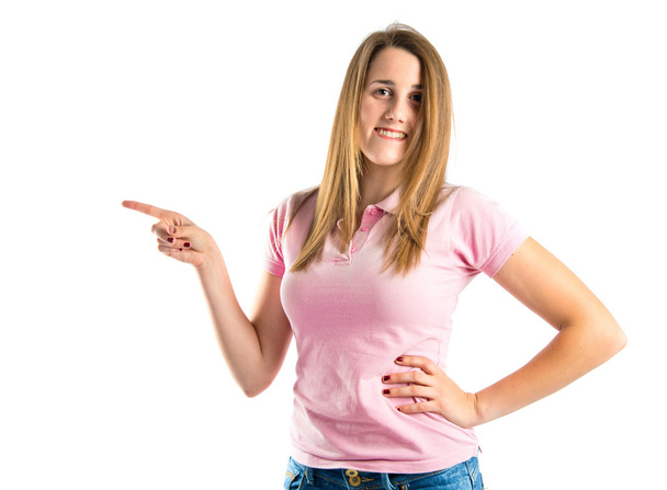 Young pretty woman pointing over white background  - Foto, Imagen