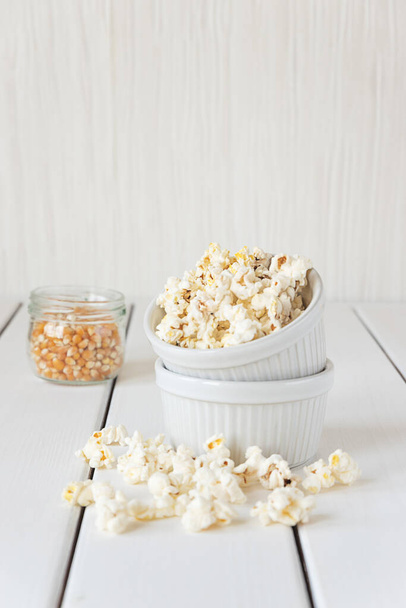 Popcorn und Maiskörner auf weißem Hintergrund - Foto, Bild
