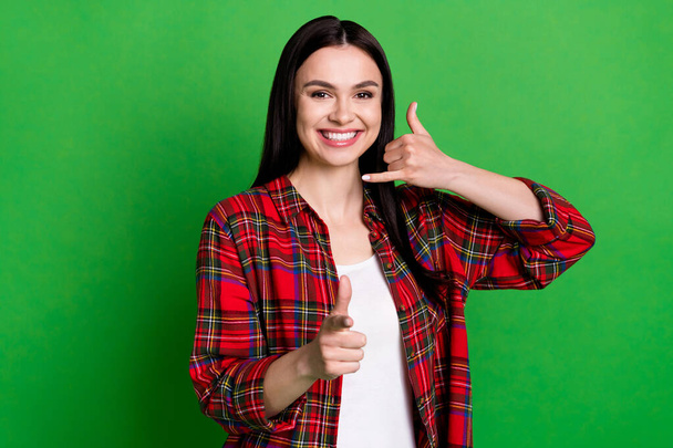 Photo of optimistic brunette hairdo millennial lady ask to call wear red shirt isolated on green color background - Zdjęcie, obraz