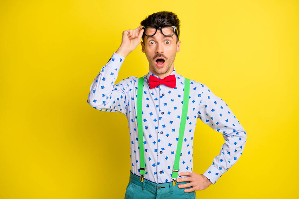 Photo of young man amazed shocked fake novelty face reaction news omg wow isolated over yellow color background - Fotoğraf, Görsel
