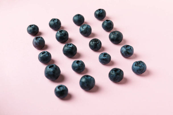 Fresh berry concept with blueberry on pink background - Foto, imagen
