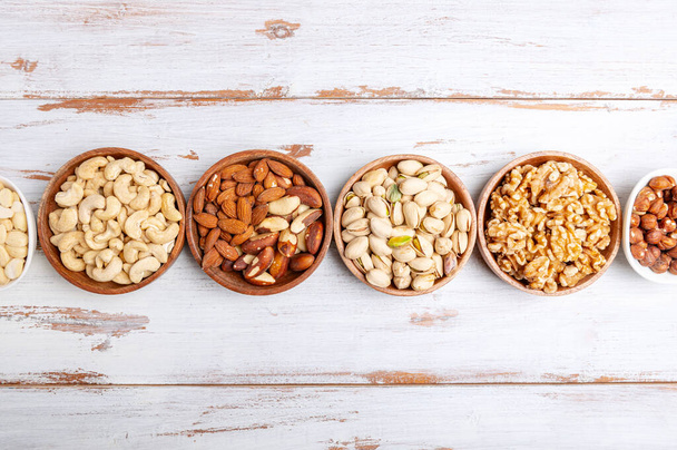 Different kind of nuts in wooden bowls - Photo, Image