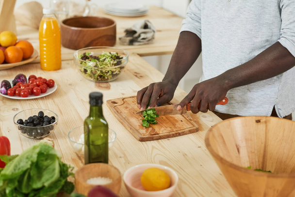 Man cutting salad in the kitchen - Photo, Image