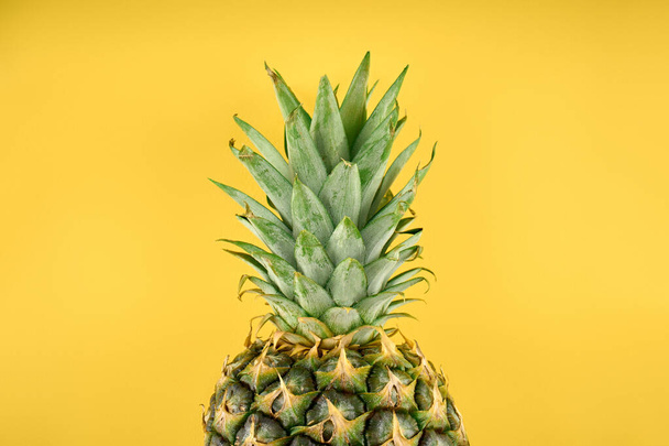 ripe pineapple isolated. Bright pineapple in minimal style. Fresh pineapples. Tropical fruits. Vegetarianism. Summer fruits. - Фото, изображение