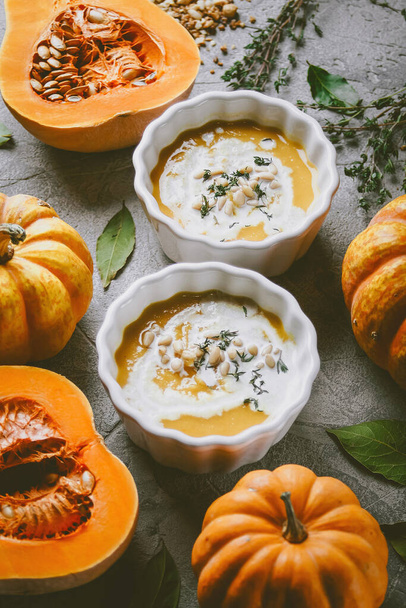 Pumpkin soup, On a gray background with pumpkins, Autumn atmosphere, Top view, Selective focus  - Valokuva, kuva