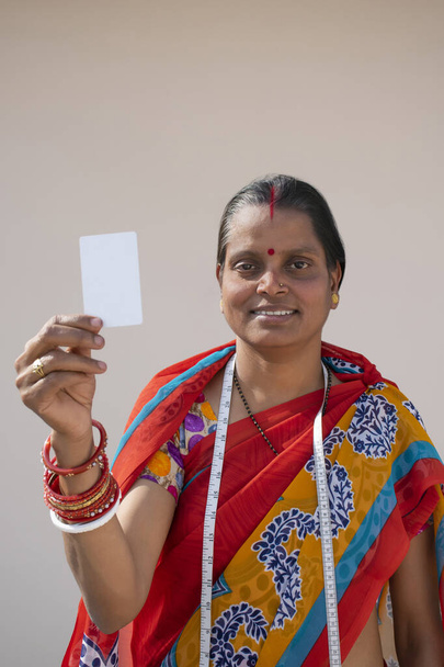PORTRAIT OF A RURAL WOMAN HOLDING CARD - Photo, Image