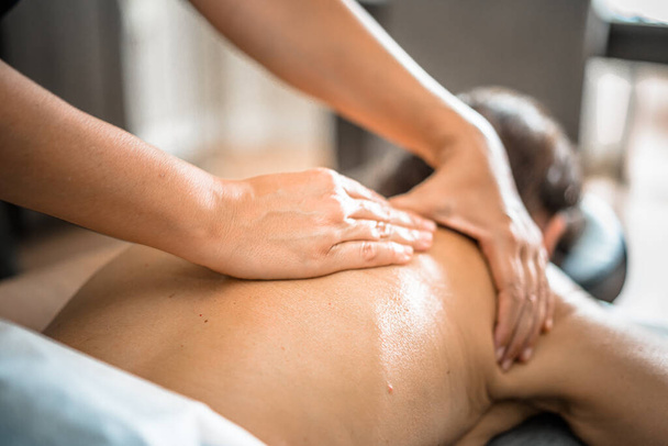 Deep tissue massage closeup view. Massage closeup with hands of professional masseur. Spa and job concept. - Foto, Bild
