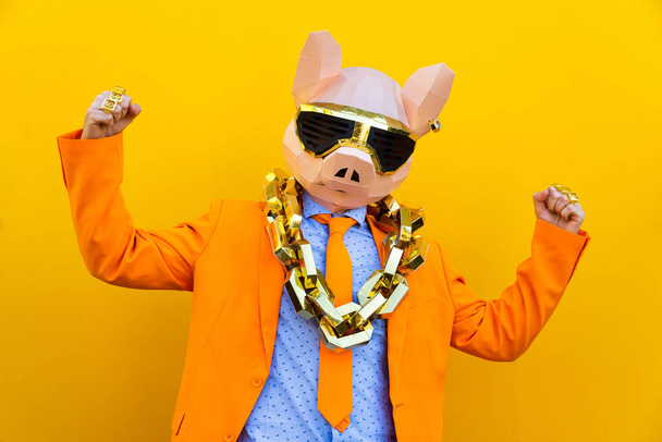 Cool man wearing 3d origami mask with stylish colored clothes - Creative concept for advertising, animal head mask doing funny things on colorful background - Fotoğraf, Görsel