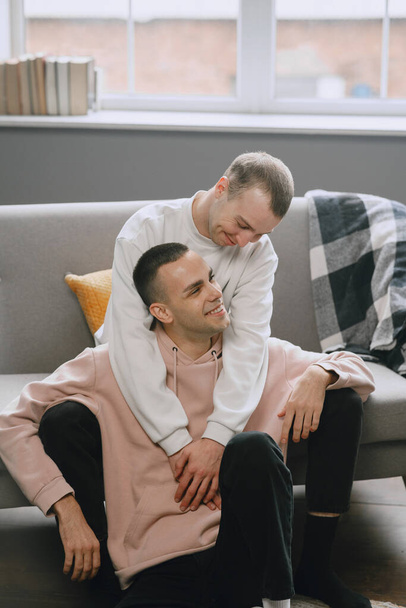 Young romantic gay couple spending day cuddling - Фото, изображение