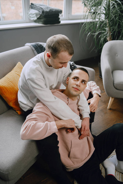 Young romantic gay couple spending day cuddling - 写真・画像