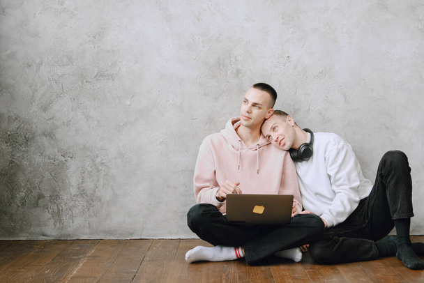 Gay couple consulting their travel plans together with a laptop - Photo, Image