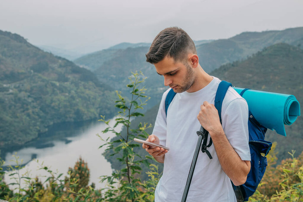 young man traveling with backpack and mobile phone - Φωτογραφία, εικόνα