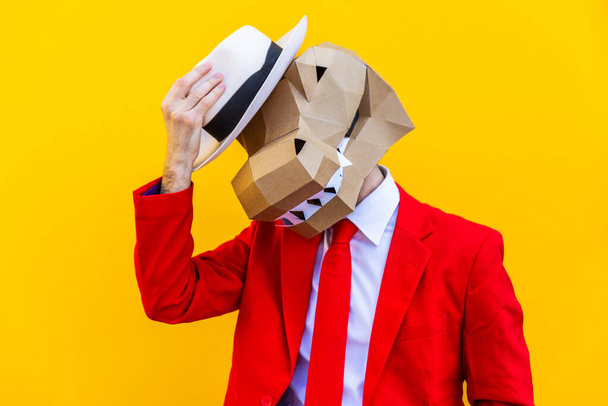 Cool man wearing 3d origami mask with stylish colored clothes - Creative concept for advertising, animal head mask doing funny things on colorful background - Foto, Imagen