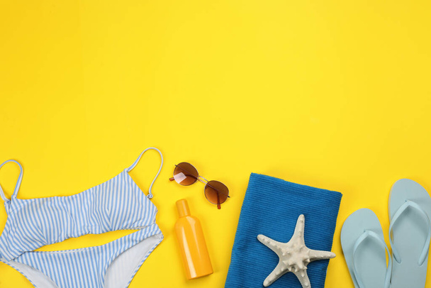 Flat lay composition with beach objects on yellow background, space for text - Φωτογραφία, εικόνα